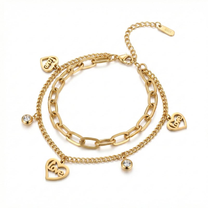 A gold bracelet made of rust-resistant stainless steel, with two layers of chains, heart-shaped pendants filled with the word Love with shiny stones, and an adjustable clasp to fit you. - Image 1
